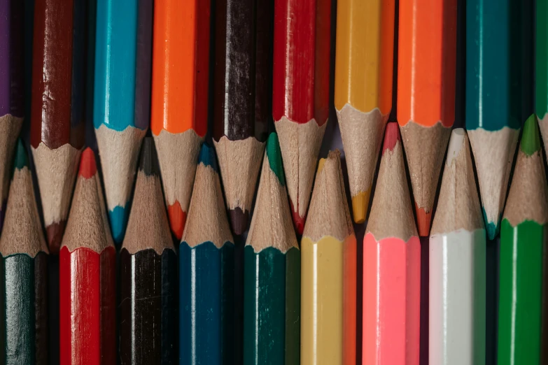 many colored pencils lined up on the wall