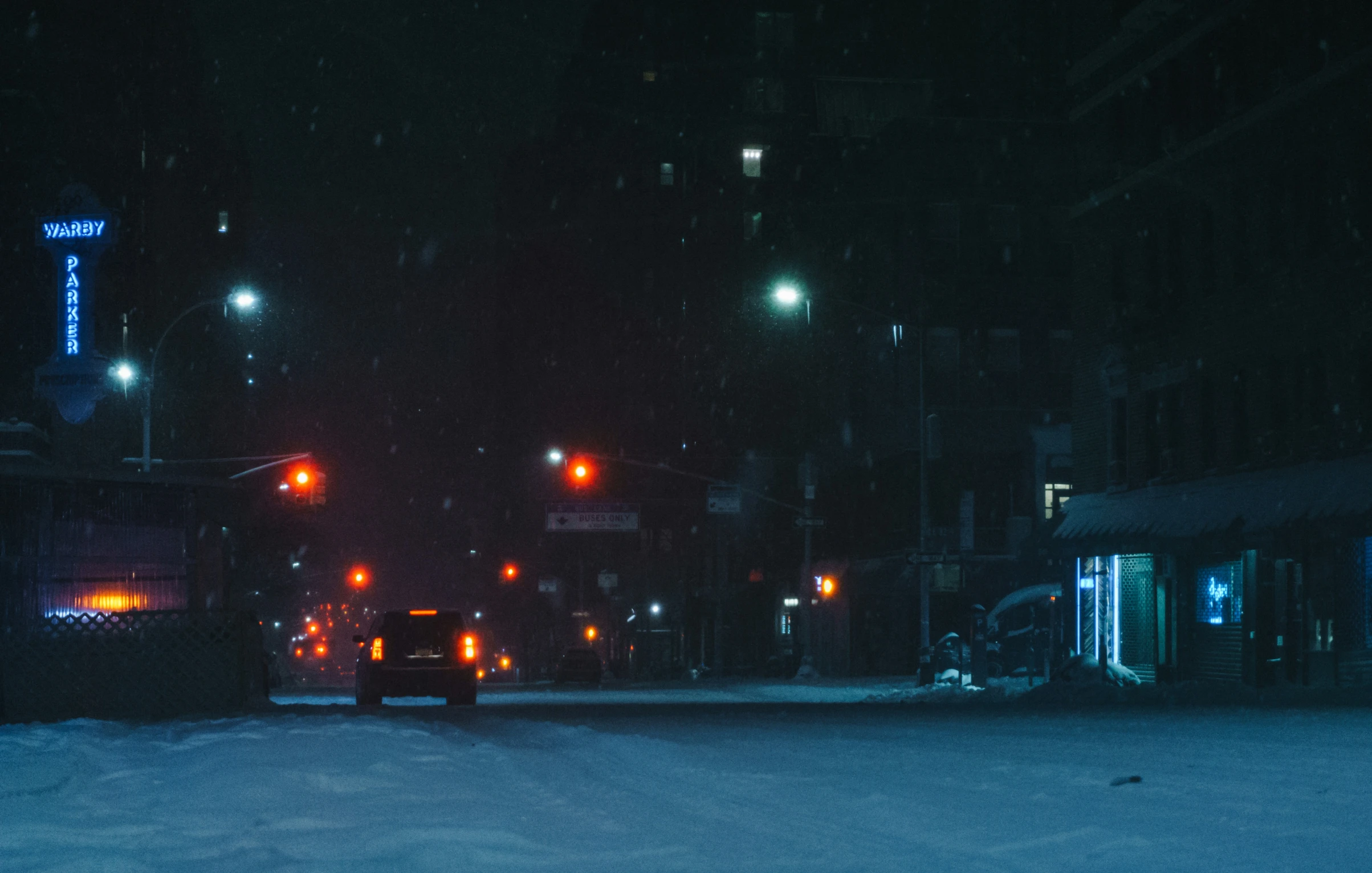 two traffic lights hanging off the side of buildings