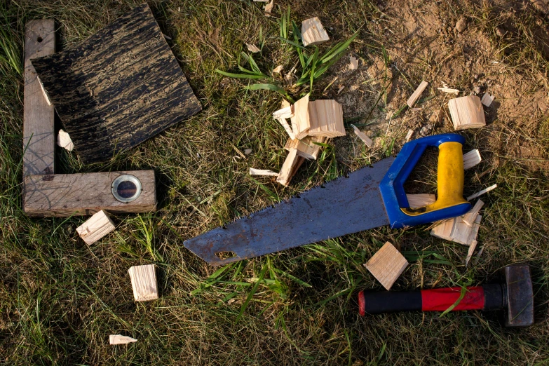 the tools needed for using this woodenworking tool are lying on the ground