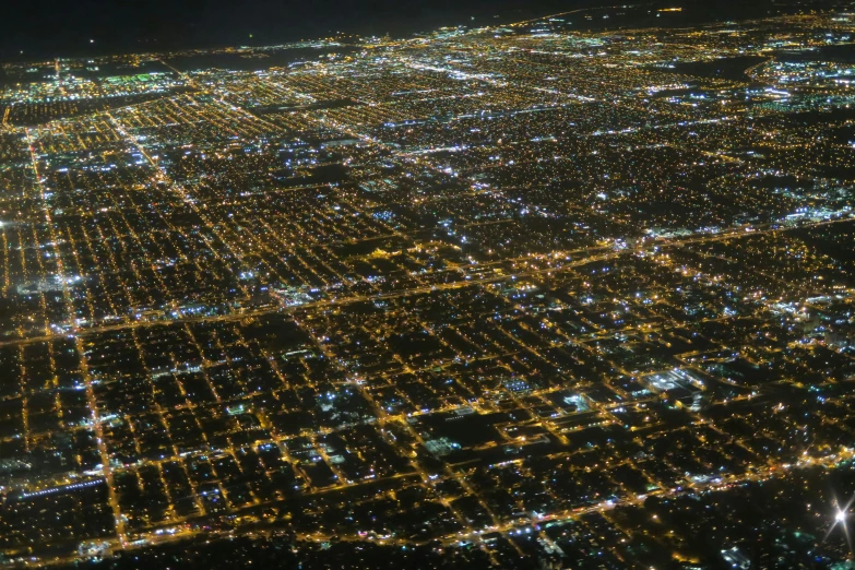 a large city lit up at night in the sky