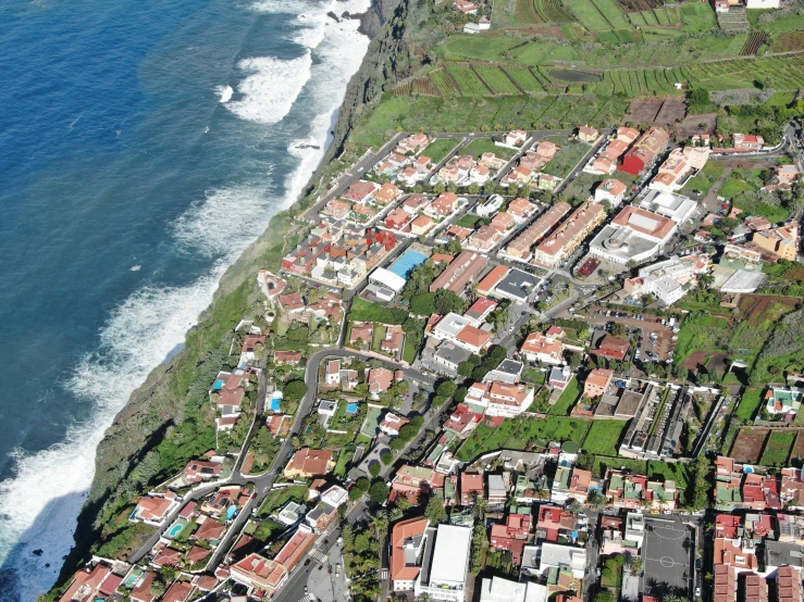 an aerial view of a city and the ocean