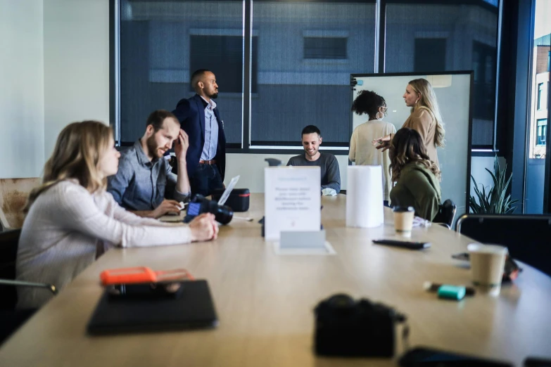 a group of people sitting around a meeting table