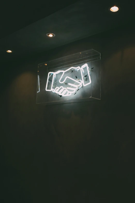 a large white neon sign above a bathroom