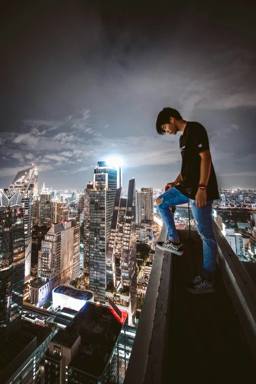 a man on a high rise in front of the city