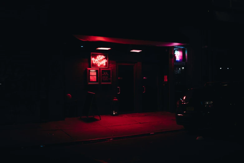 red neon signs in black buildings at night