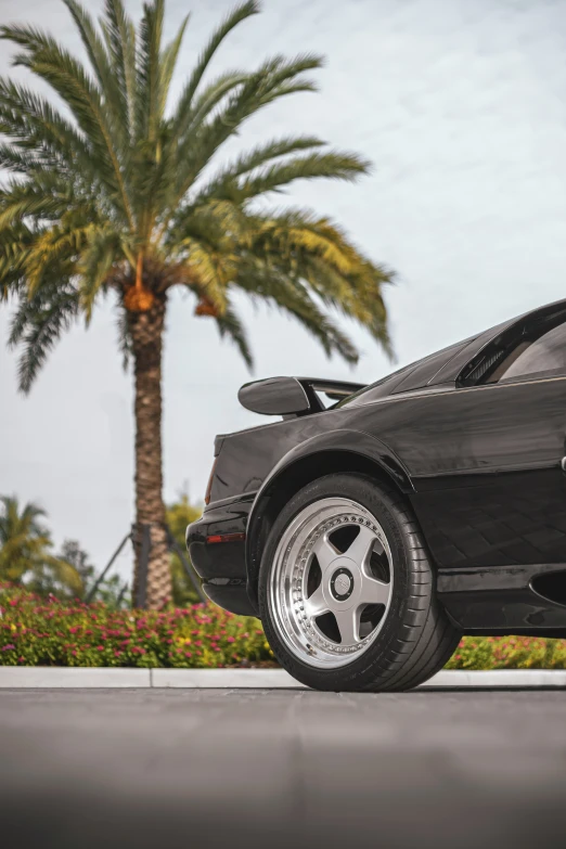 this is a black sports car parked on the side of the road