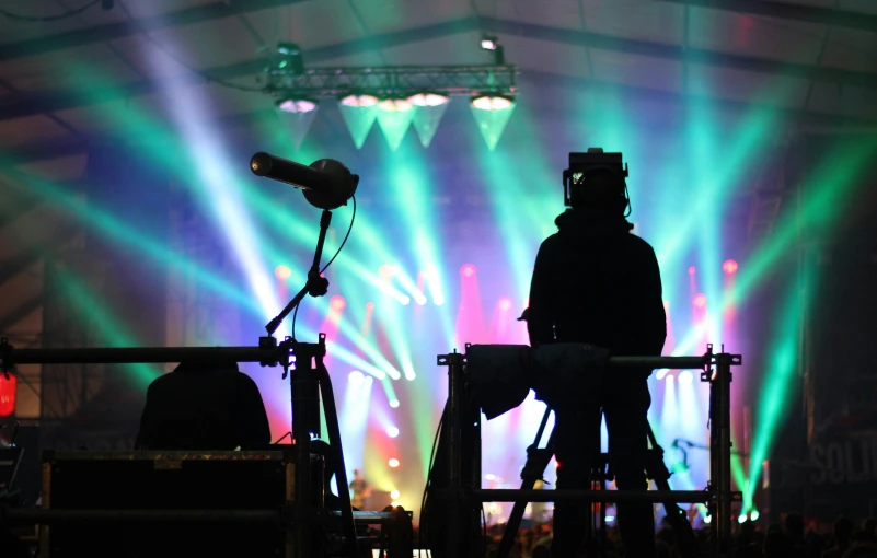 some djs playing instruments under bright lights