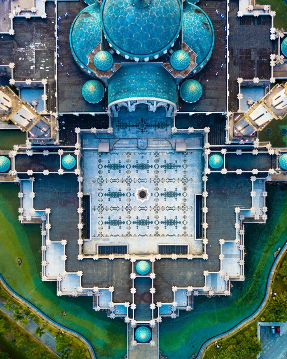 an aerial view of a building with lots of green grass