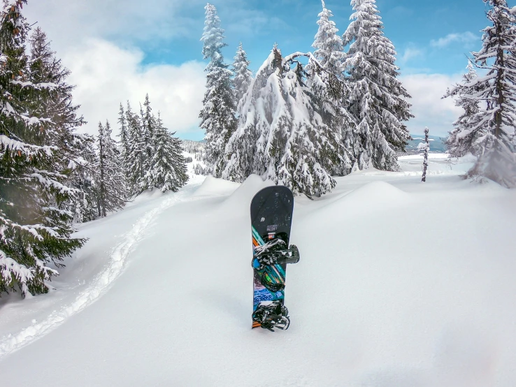 a person riding a snow board on top of a snow covered hill