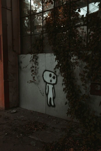 a wall with a graffiti of a character standing next to a window