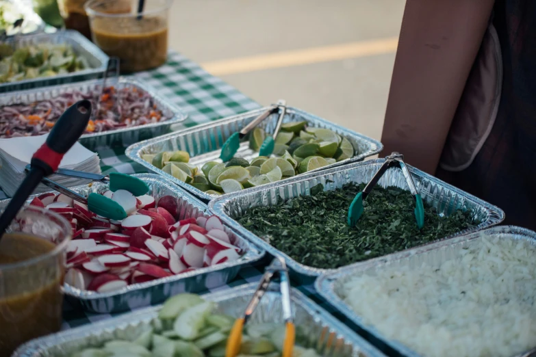 trays of various vegetables being prepared in an outdoor display