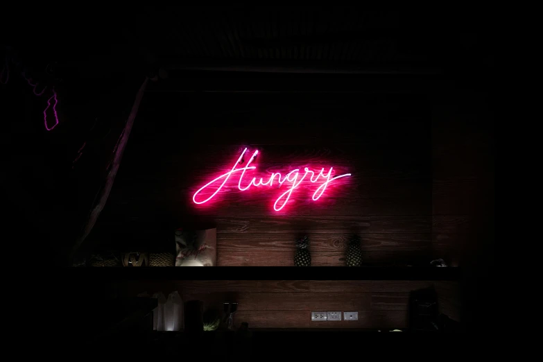 a neon sign that says happy above a building