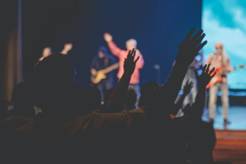 an audience is at the stage and clapping