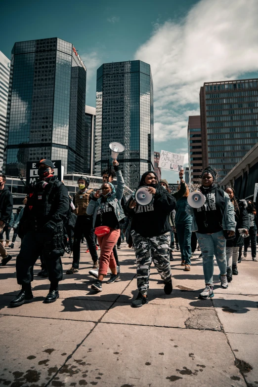 a group of young people walk with skateboards in hand