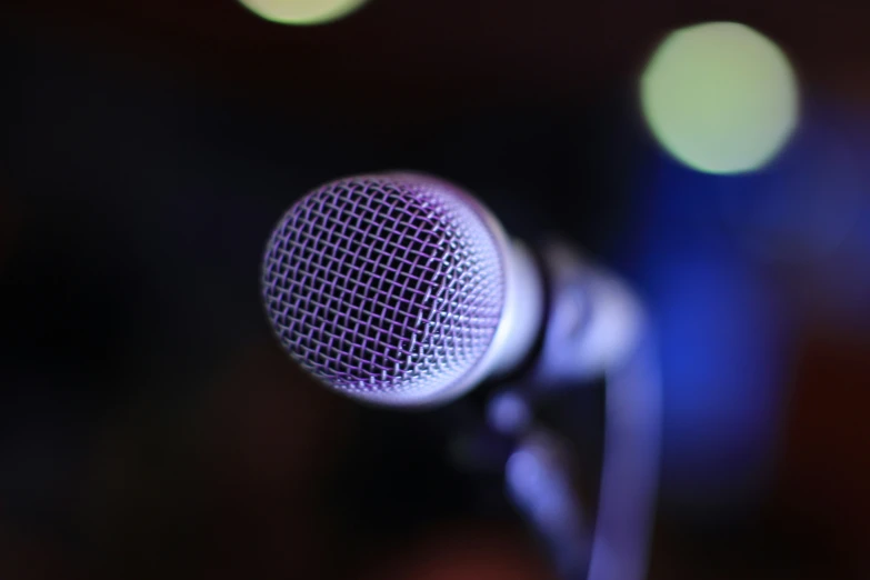 a microphone on a black stand at the corner of a room