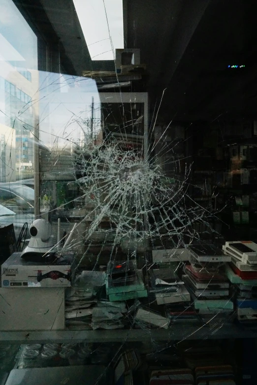 shattered window of bookshelf next to large window