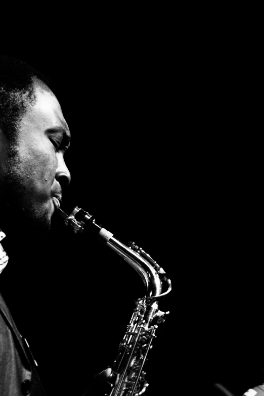 a black and white po of a person playing a saxophone