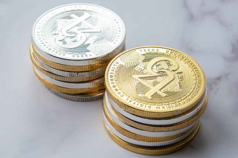 five gold and silver coin laying on white surface