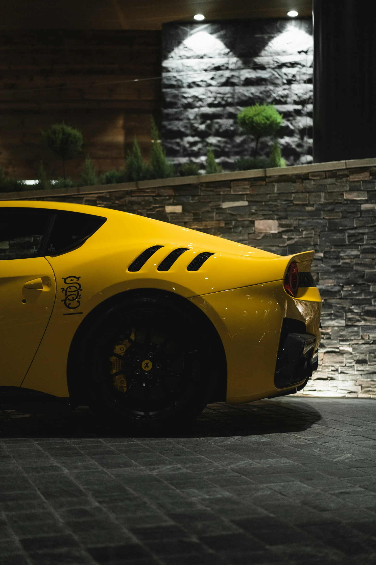 a yellow car sitting in a parking lot