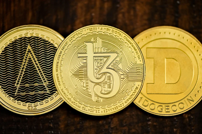three gold coins with different designs are shown