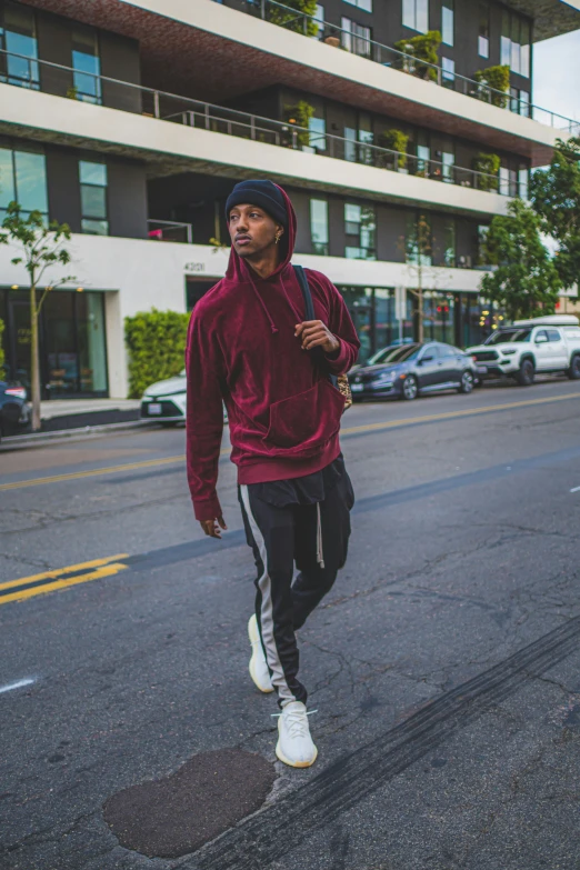 a man in a red jacket jogging on a city street