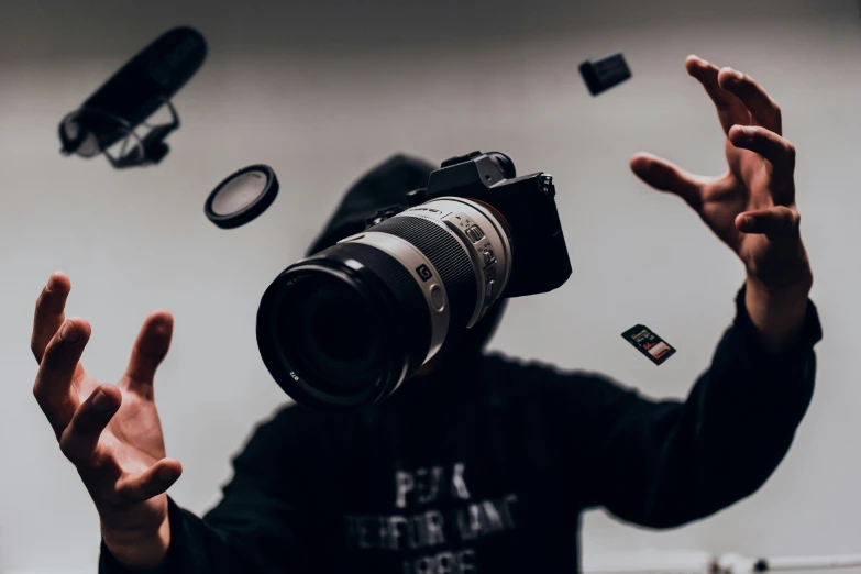 a person holding a camera and jumping into the air