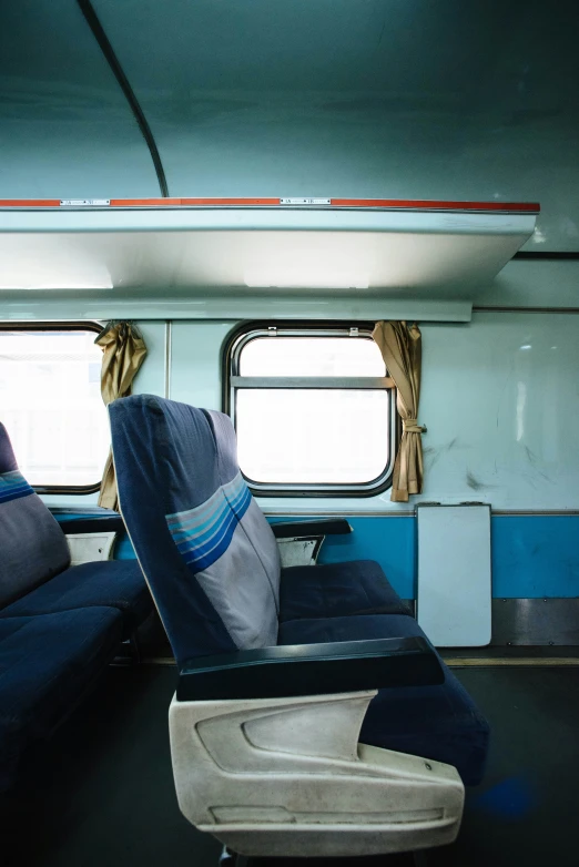 two people who are sitting in a chair on a train