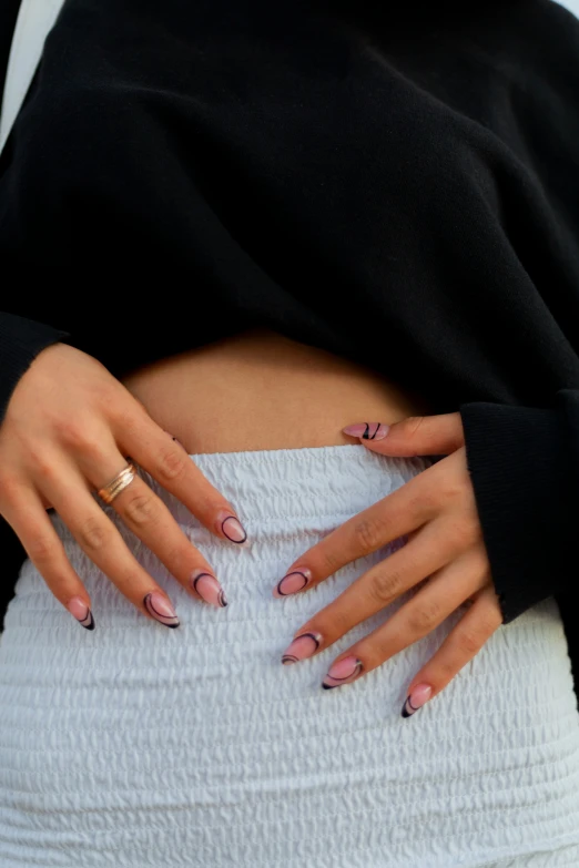 a person with a ring and manicured nail polish