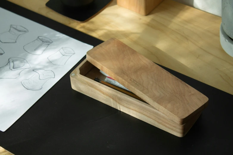 a wood box with a knife in it sitting on a table