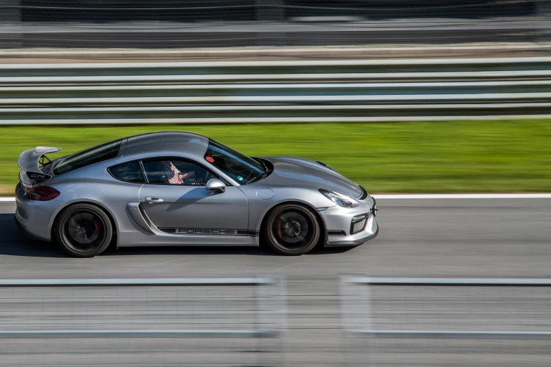 a sports car is driving down a race track