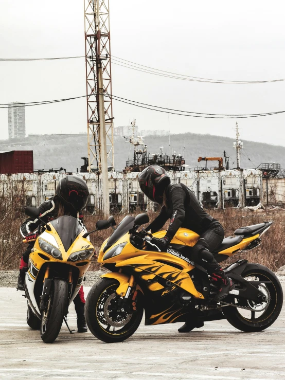 a man on a motorcycle parked near another man