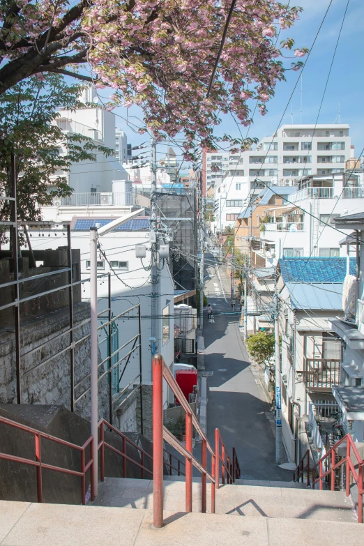 view from behind of stairs overlooking a street and buildings