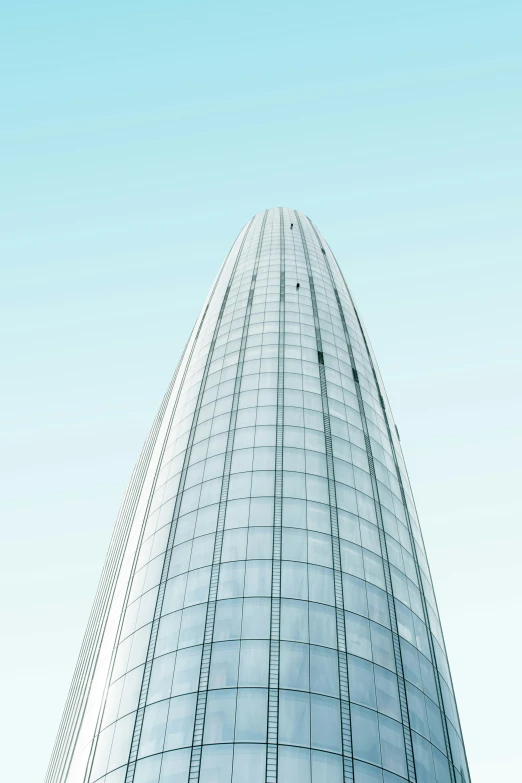 the top of a building is reflected in a clear window