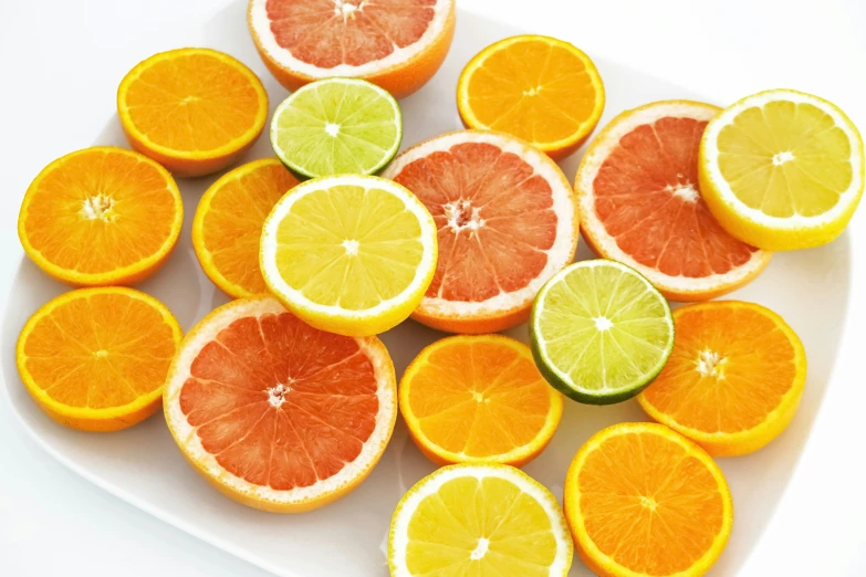 a platter filled with citrus fruits sliced in half