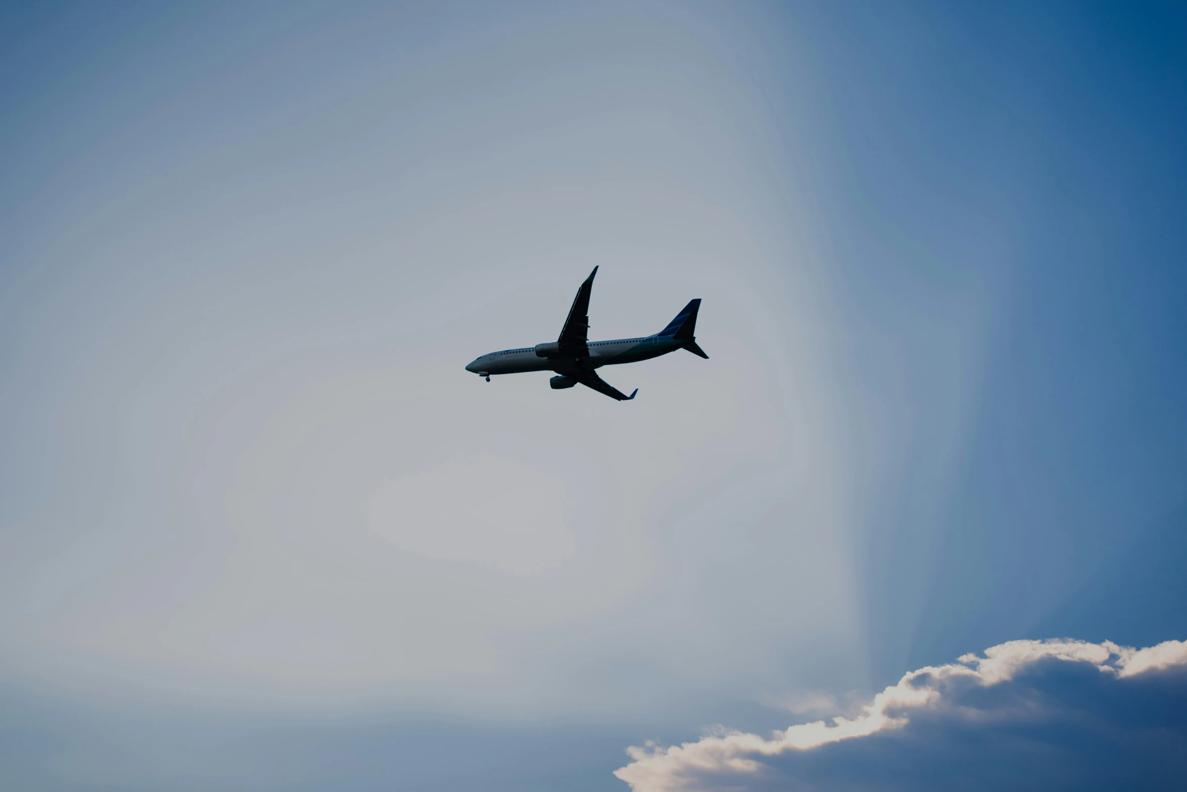 the airplane is flying in the sky, leaving a trail of smoke