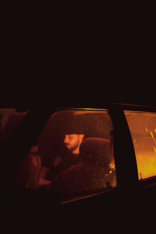 a person in a car driving in the dark