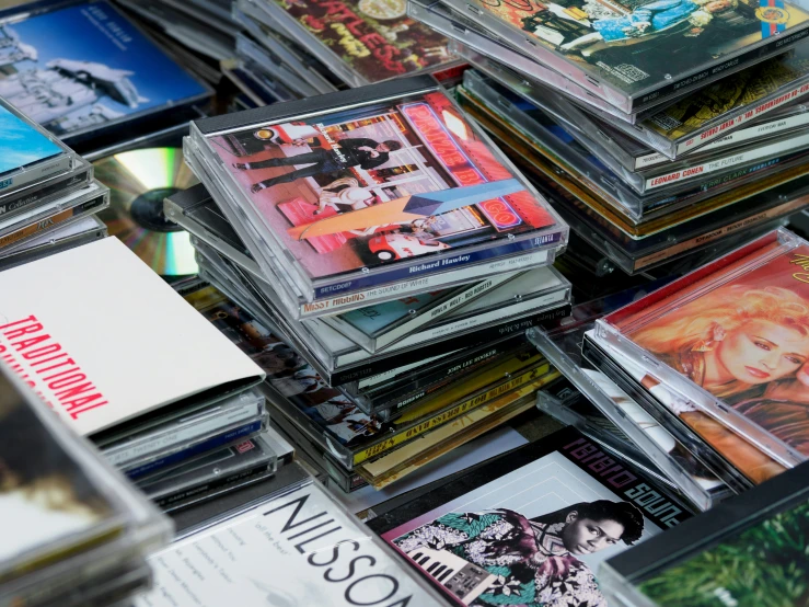 many cd cases stacked up on the ground