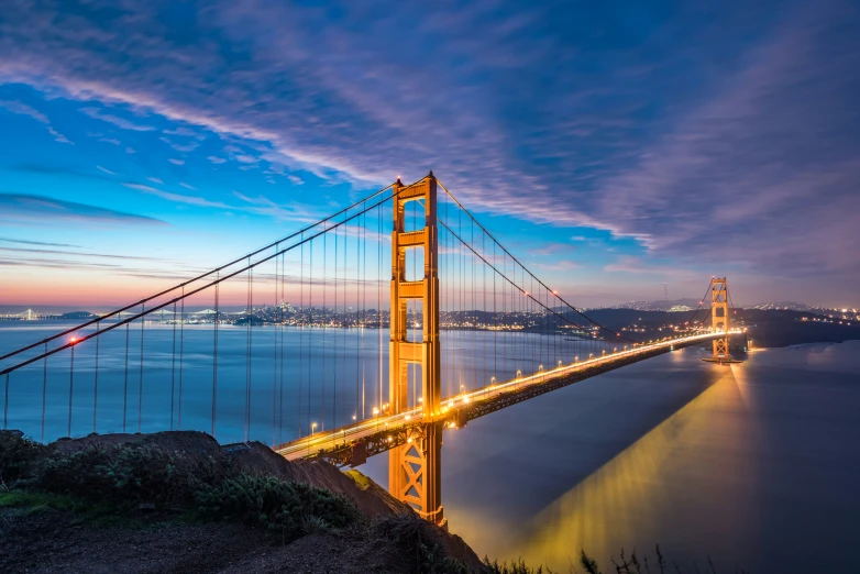 the golden gate bridge is lit up in bright lights