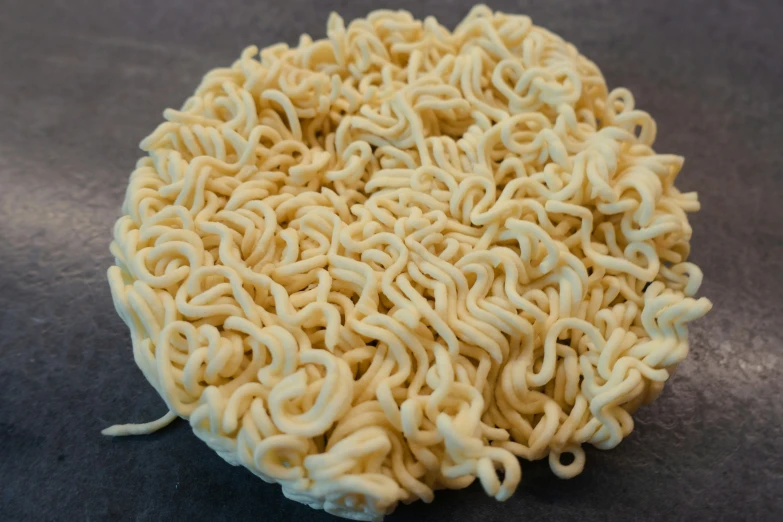 a plate full of noodles with sauce all over the rim