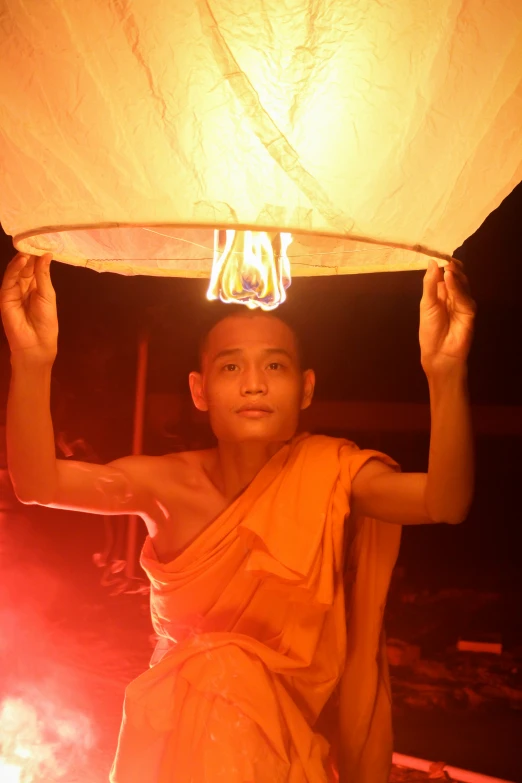 a man with a white lantern over his head