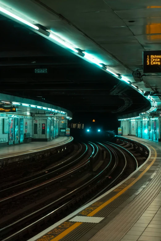 a train platform with some trains on it and a stop light