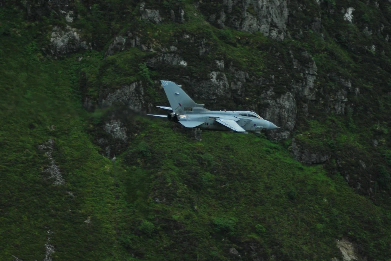 an army plane sitting out in the grass