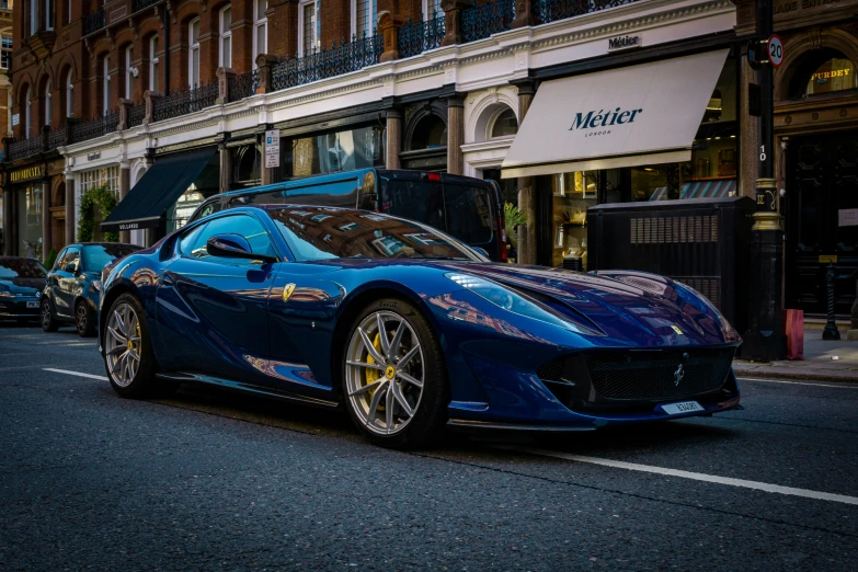 a blue sports car parked at the curb