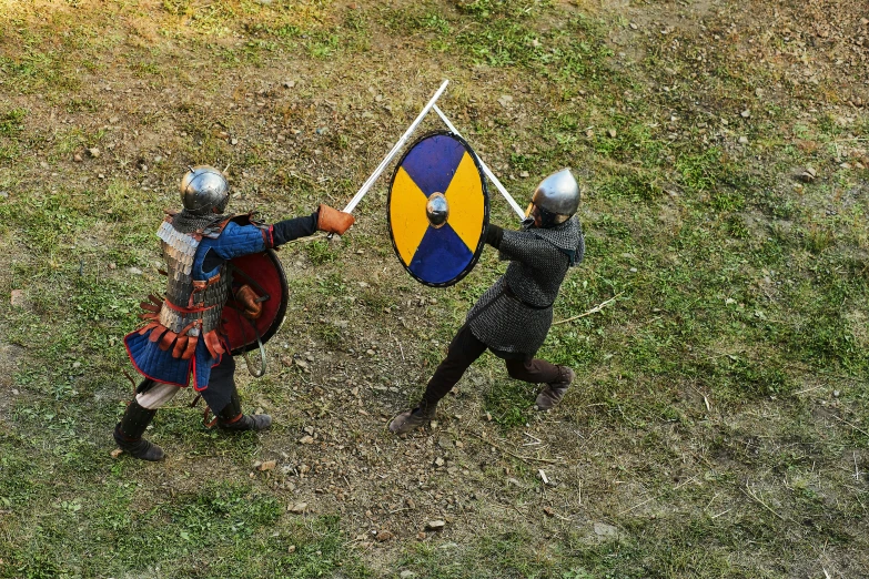 two children dressed as knights holding a flag