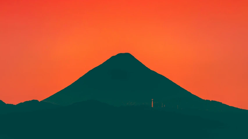 a red sky and some silhouettes of a mountain