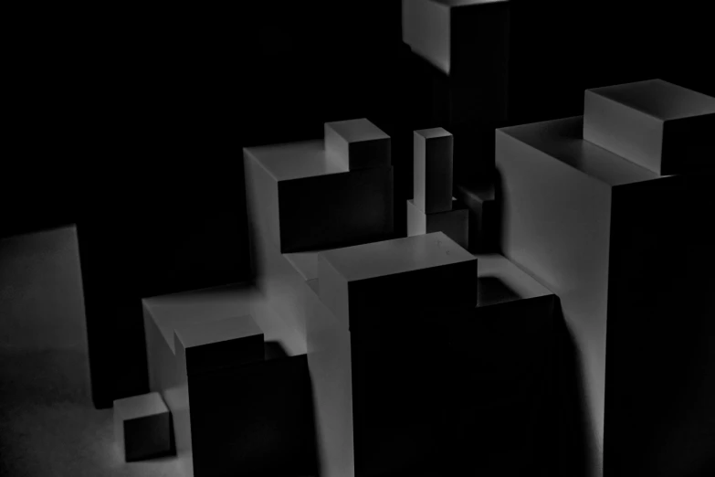 a monochrome picture of several small blocks in a dark room