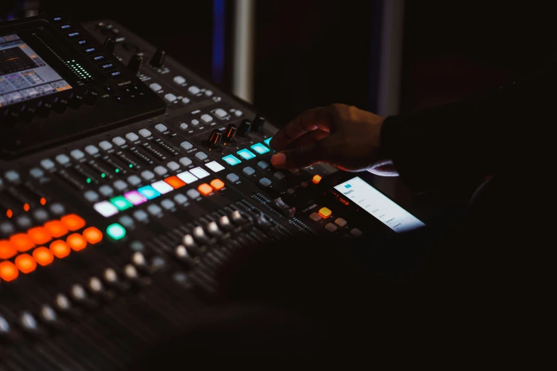 a soundboard mixing with electronic devices in the dark