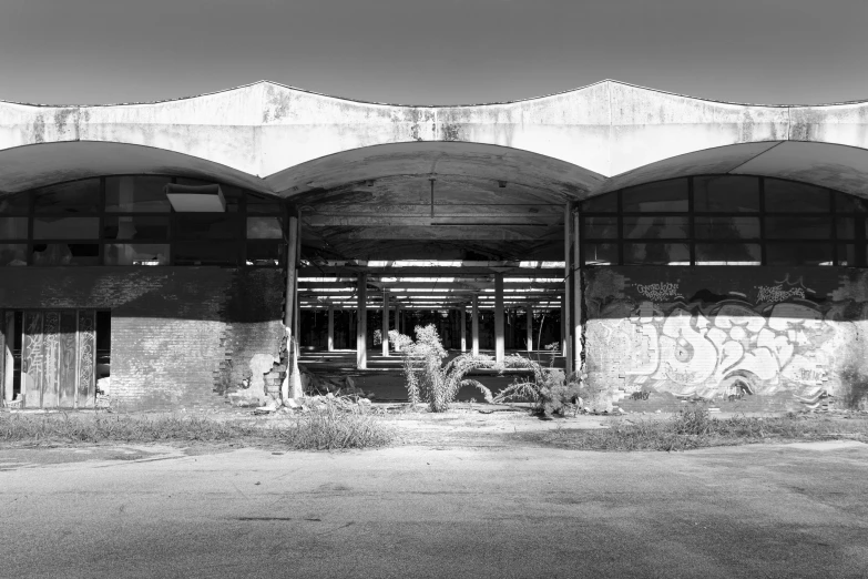 a black and white image of an old building with graffiti