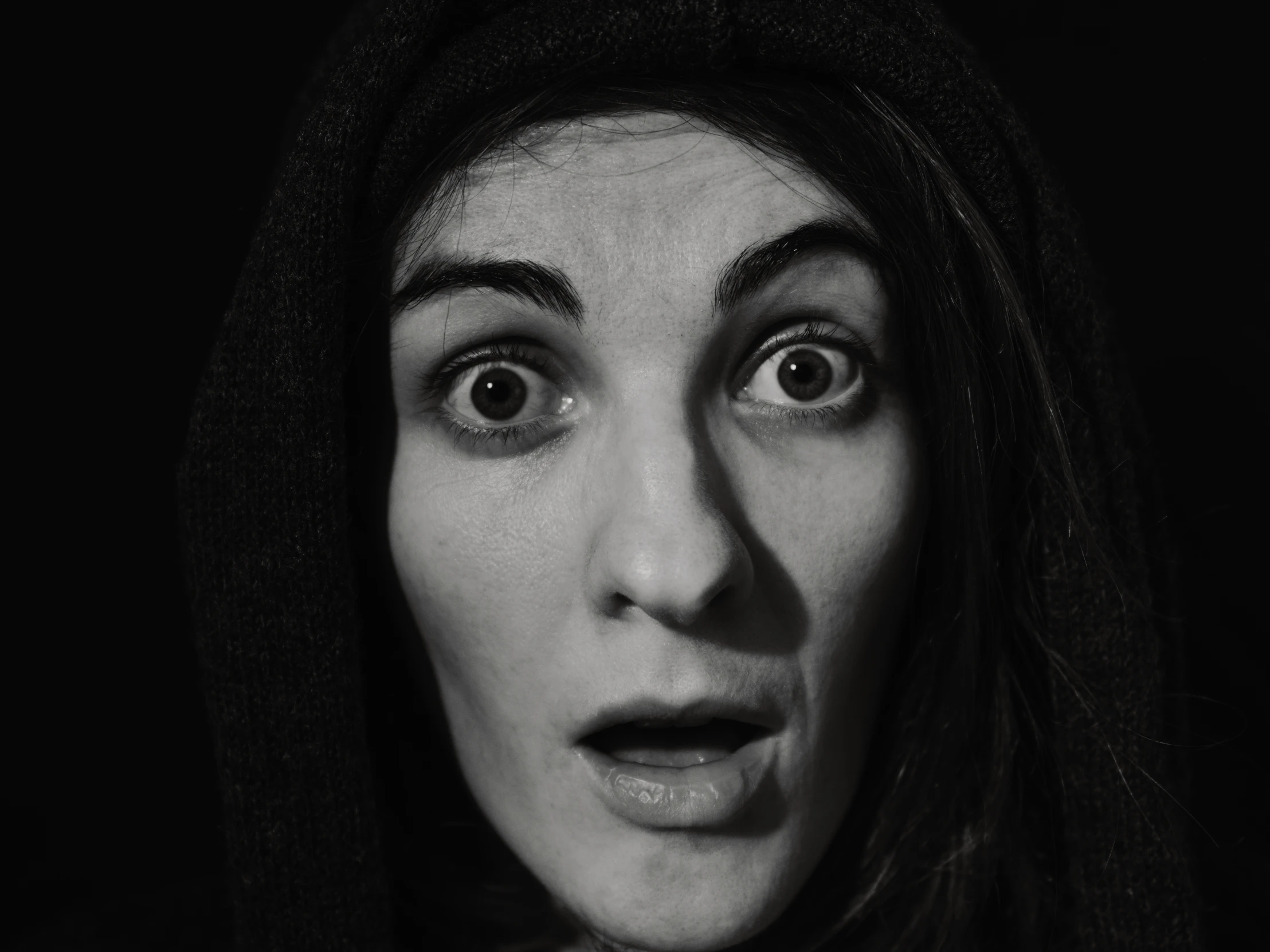 a black and white po shows the face of a woman