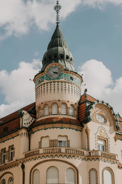 an architectural building in front of a partly cloudy sky